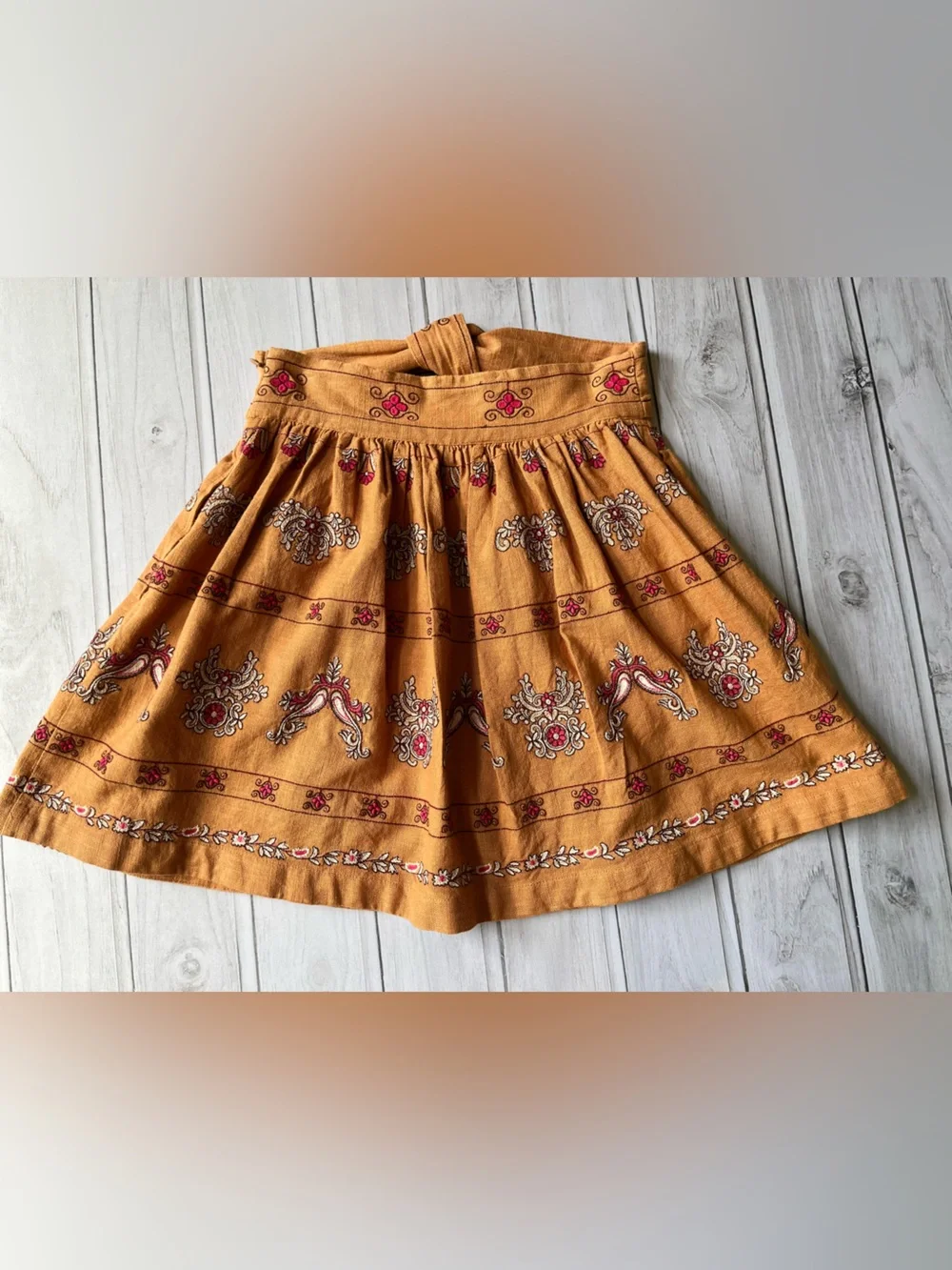 Anthropologie Meghan terracotta embroidered folkloric mini wrap skirt. Size 0